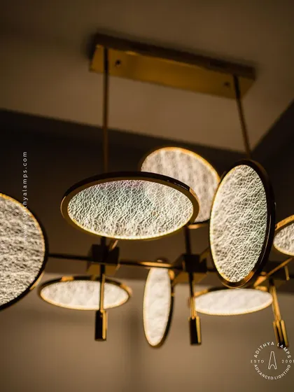 This artistic chandelier is composed of multiple circular discs with a unique woven texture. The layered arrangement and soft backlighting create a beautiful interplay of light and shadow, making it a captivating centerpiece.