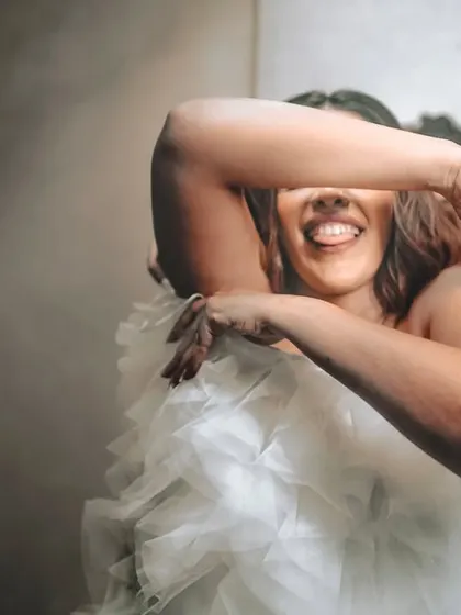 A playful, happy moment of the bride in her beautiful dress.