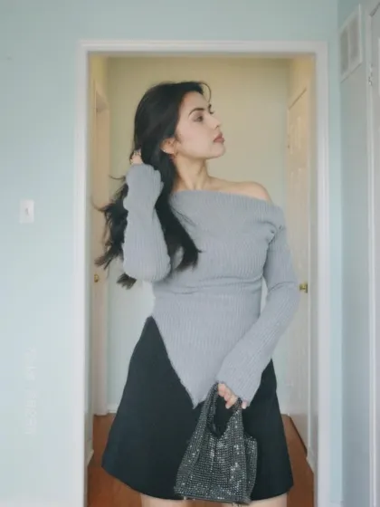 Another pose in the stylish grey top, perfect for a lunch date.