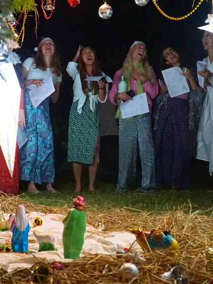 Celebrating the holiday season with Christmas carols around a nativity scene. We love sharing cultural traditions from all over the world.