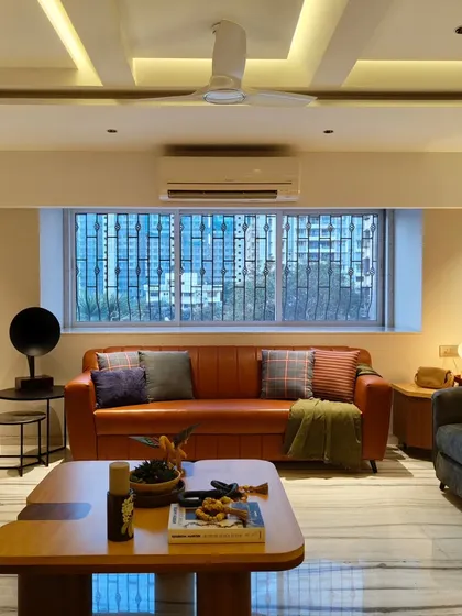 Another angle of the Mulund living room, showing the view of the city from the large window. The design ensures the space feels open and connected to the outdoors.