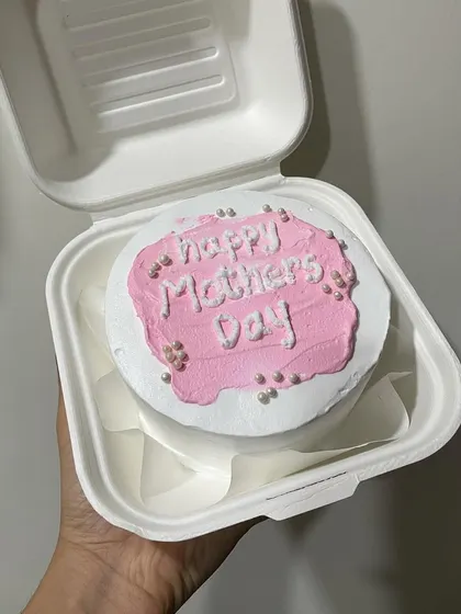 A pink "Happy Mother's Day" bento cake with pearl sprinkles.