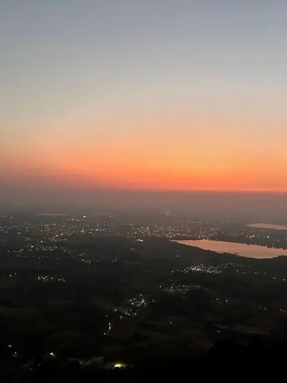The sky painted in hues of orange and pink during sunrise at Skandagiri. A truly magical sight that makes the early morning start worthwhile.