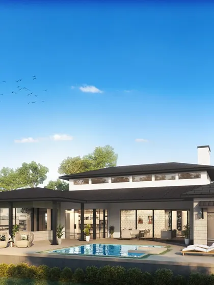 The rear view of the ranch-style home, revealing a spacious patio and pool area designed for relaxation and entertainment.