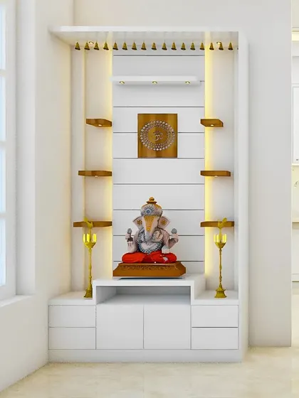 Situated next to a large window, this bright white pooja unit maximizes natural light. We used contrasting wooden shelves and subtle integrated LED strips to highlight the altar, creating an open, airy, and peaceful space for daily prayers.