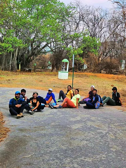 A team rests at the base of Kaiwara Betta. Our treks are not just about the peak, but about enjoying the entire journey together.