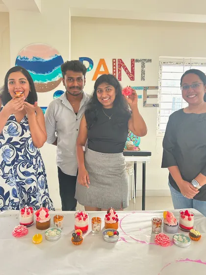 A repeat of a happy group posing with their dessert candles, emphasizing the fun and creative output.