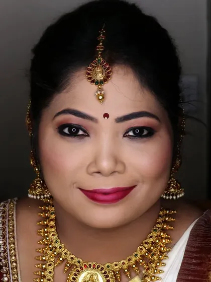 A portrait of Sowmya looking radiant and confident. The classic red lip and defined eyes are a timeless choice for any South Indian bride.