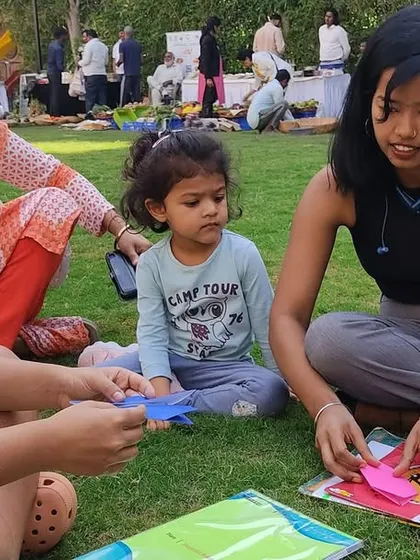 Young learners engaged in a paper craft activity at the Kids Kona. We encourage children to share their skills and learn from each other in a supportive and creative environment.