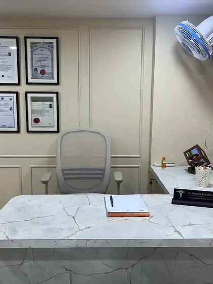 A closer look at the consultation desk, where every detail is organized to focus on you. The framed certificates are a testament to my extensive training in dermatology and hair transplant surgery.
