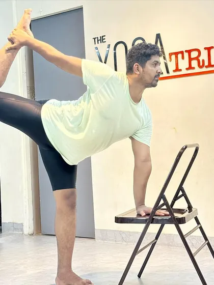 Using a chair for support in Natarajasana helps to build confidence and muscle memory for the full expression of the pose.