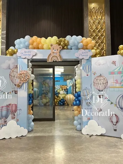 A grand entrance arch for the hot air balloon party, with custom printed backdrops and balloon clusters.