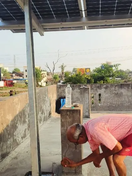 A customer breaks a coconut to bless his new solar installation, a beautiful tradition we respect.
