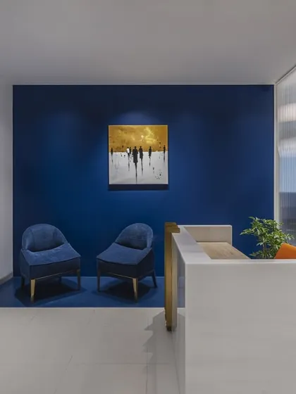 The reception area of this Mumbai headquarters was designed to make a strong first impression. A serene blue wall, modern furnishings, and the company logo create a welcoming yet professional atmosphere that sets the tone for the entire office.