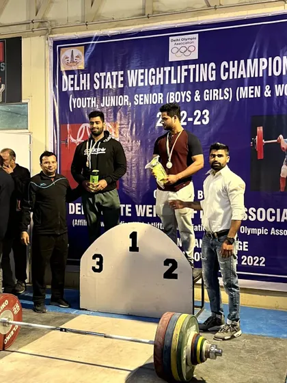 Standing on the podium with the winners. My role as an official is to support the athletes and celebrate their achievements on the platform.