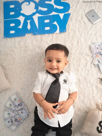 A top-down view of our little executive with his briefcase and money. This angle provides a unique and creative perspective for his portrait.
