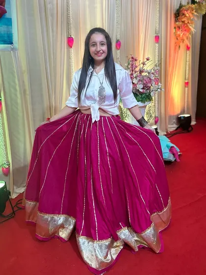 A happy moment in my pink and white Indo-Western outfit at a Chaitra Navratri event.