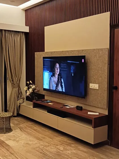 A simple and classy TV unit with a wood-paneled accent wall. The design is clean and functional, providing a perfect focal point for the living room.