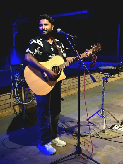 A candid shot from a live performance, just me and my guitar. I love connecting with the audience through my music in these settings.