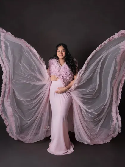 Feeling like an angel waiting for my little one. This portrait with dramatic wing-like fabric is a creative and empowering way to celebrate the magic of pregnancy in the studio.