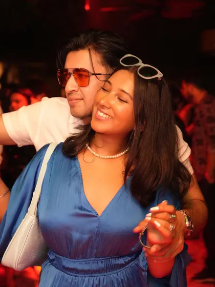A sweet moment between friends on the dance floor.