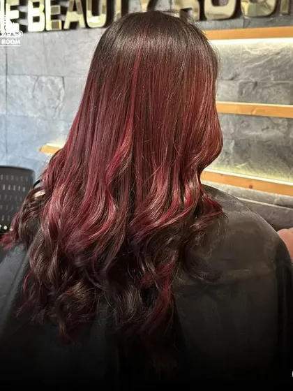 Another angle of the vibrant red tones, styled with soft waves.