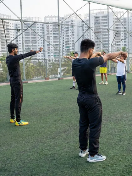 Our trainers demonstrating proper stretching techniques to the group, emphasizing the importance of warm-ups and cool-downs.