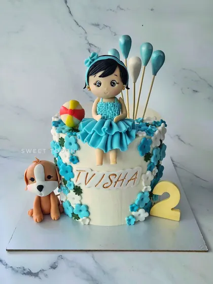 All of Tvisha's favorites on a cake for her second birthday. This pineapple cake features a cute figurine, her puppy, a ball, and lots of flowers.