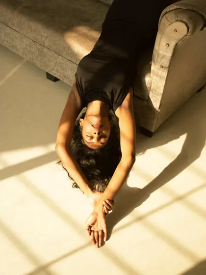 An artistic shot using the patterns of natural light from a window. The model is bathed in the warm morning sun, creating a tranquil and beautiful image.