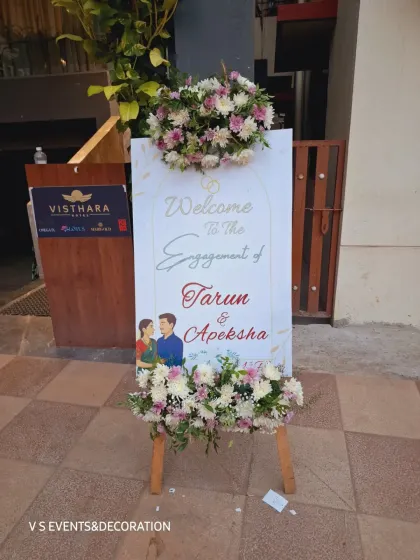 A personalized welcome sign is the first thing your guests see. For this engagement, I created a custom easel board with the couple's names and illustration, decorated with fresh floral arrangements to set a warm and inviting tone for the celebration.