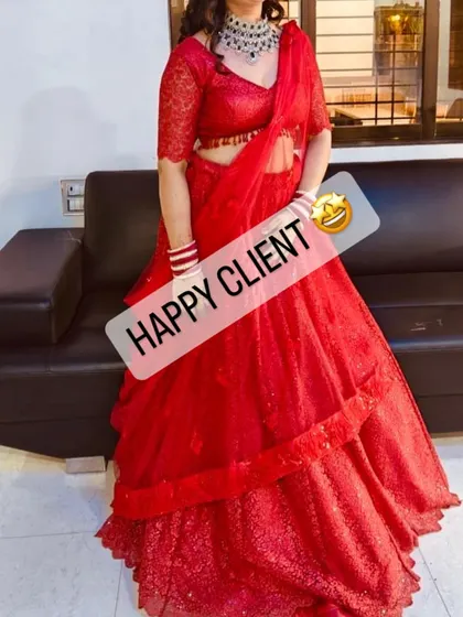 A happy client looking radiant in a red sequined lehenga, perfect for a wedding reception or the main ceremony.