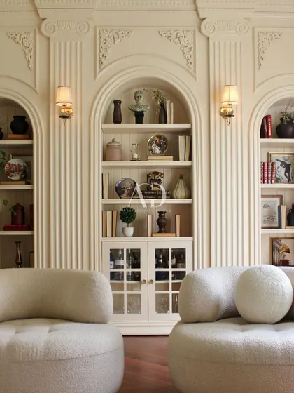 The full view of this Parisian-inspired lounge area, where modern, comfortable seating is set against a backdrop of exquisite classical architecture. It is a space designed for stylish relaxation.