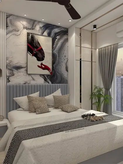 A luxurious master bedroom render with a statement art piece above a grey upholstered headboard. The design incorporates mirrored panels and a large window with city views, creating a bright and sophisticated room.