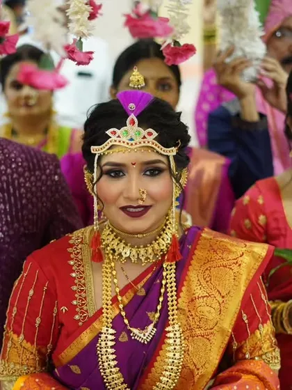 The grand entrance of a Maharashtrian bride. Dressed in a traditional Nauvari saree, her look is completed with authentic jewelry and a bold makeup look that reflects the richness of the culture.
