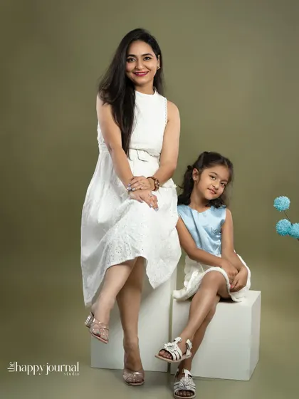 A duplicate of image 27, a stylish portrait of a mother and daughter in white, showcasing their close and happy relationship.