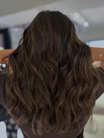 A classic two-tone mocha and beige highlight blend on mid-length to long hair. The long layers haircut adds texture and movement, beautifully showcasing the color.