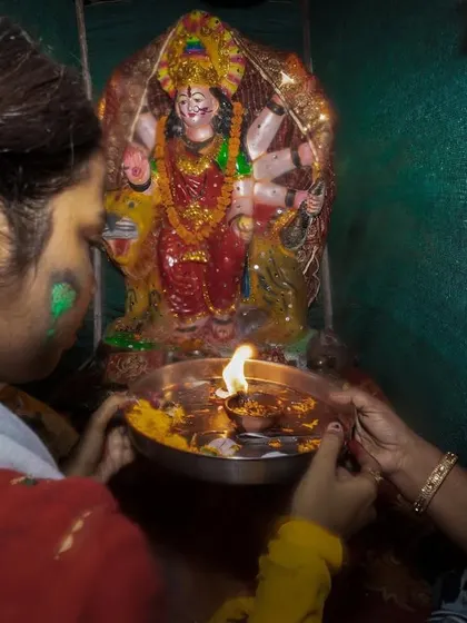 Devotees perform aarti for a goddess idol before its immersion during a Visarjan ceremony in Delhi.