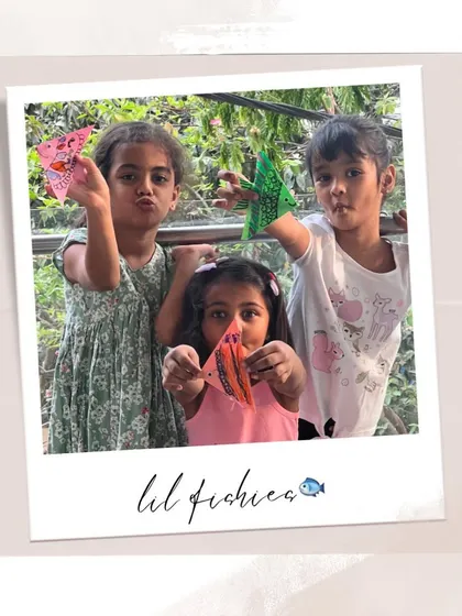 Our "lil fishies" posing with their colorful origami fish. They had so much fun decorating them with their own patterns.