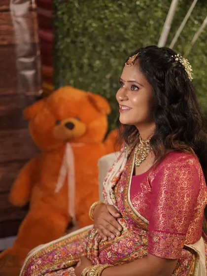 A solo portrait of the mom-to-be at her baby shower. She looks serene and beautiful, surrounded by festive decorations.