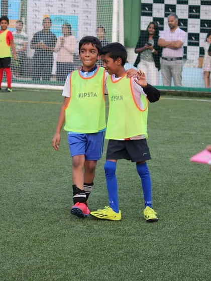 Football teaches sportsmanship and friendship. Here are two teammates sharing a moment of camaraderie during a break in the game.
