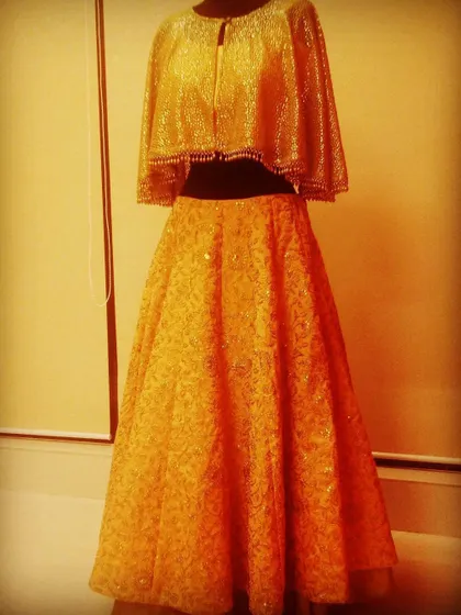 This golden cape and skirt set is a classic that clients keep asking for. The shimmering fabric and elegant cape blouse make it a go-to choice for evening receptions and parties. Seeing it worn always makes me a happy designer.