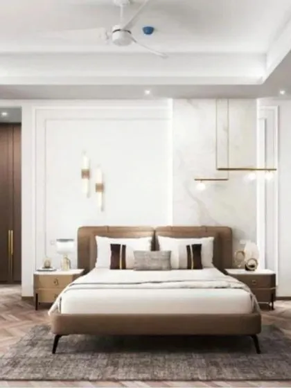 A bright and airy bedroom with herringbone wood flooring and modern pendant lights flanking the bed.