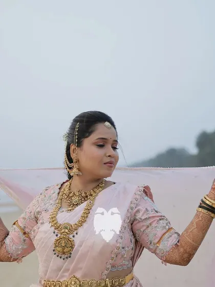 Purvi looking ethereal on the beach in her blush pink blouse.