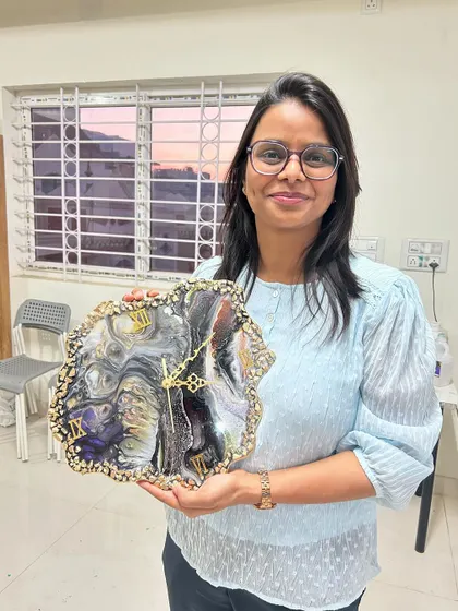 This guest is thrilled with her large, dramatic geode resin clock in black, white, and gold.