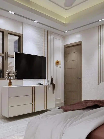 A view of the TV and console in a modern bedroom. The design features a floating white chest of drawers and a unique headboard with an abstract, mountain-inspired shape, adding an artistic touch.