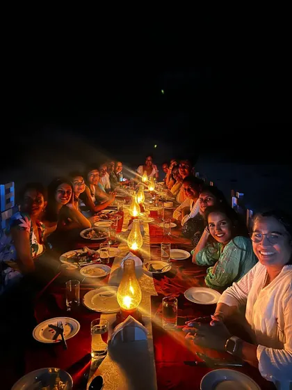 A beautiful long-table dinner set up right on the sand. Sharing meals by lantern light is one of the most cherished parts of our retreat experience.