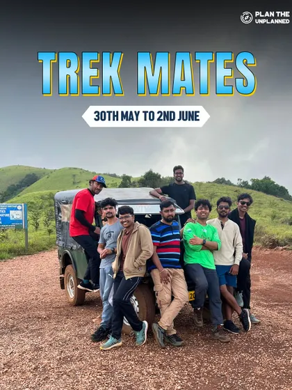A group of friends posing with their jeep, a key part of the adventure on treks like Kudremukha.
