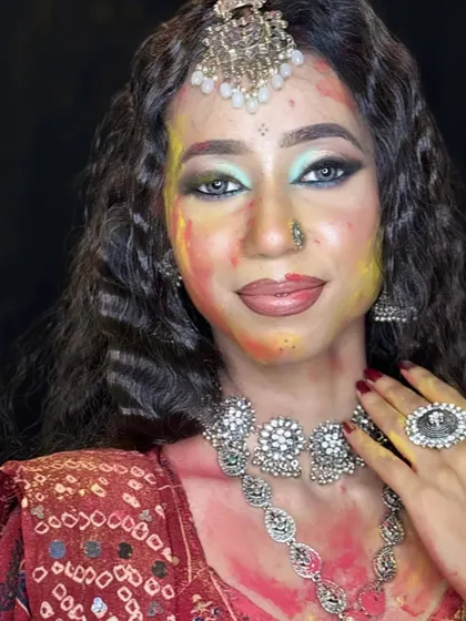 A full-face portrait of the Holi look, showcasing the beautiful contrast between the colorful powders and the glam eye makeup.