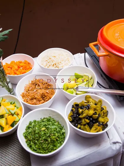 A live station setup with various toppings and condiments for a build-your-own bowl concept. This allows for guest customization and caters to different dietary preferences.