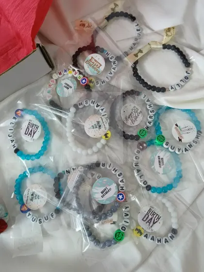 Another look at a bulk order of our boys' name bracelets, perfect for party favors. Each one is sealed and ready to be gifted.